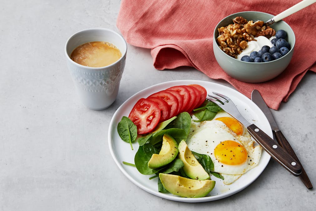 Simple liberal low carb breakfast with fried eggs and yogurt
