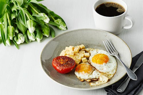 Keto breakfast with fried eggs, tomato and cheese